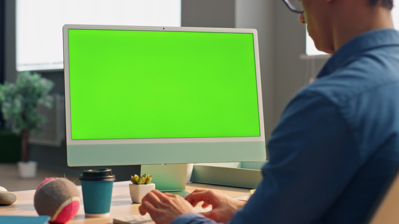Freelancer using green screen computer in office close up. Business man working