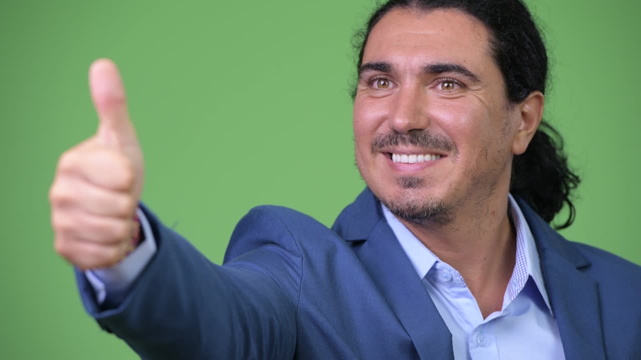 Handsome businessman giving thumbs up