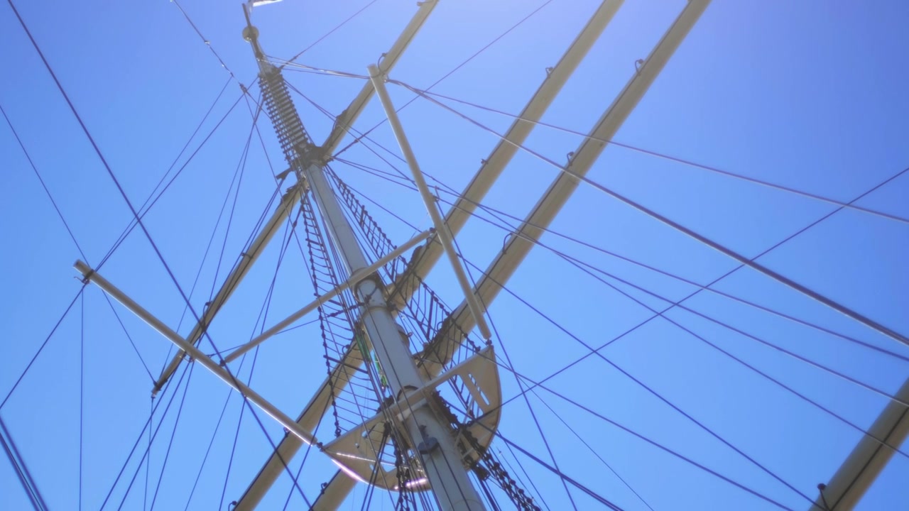 Alberi di una nave a vela tradizionale del XIX secolo (Rickmer Rickmers). Ripresa dal basso con un cielo azzurro limpido. Movimento di inclinazione della telecamera.