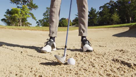 video of legs of african american man playing golf on golf field