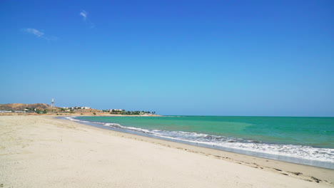 gorgeous zorritos beach in tumbes, peru, on a sunny day, with the tides of the blue and emerald sea hitting the shore