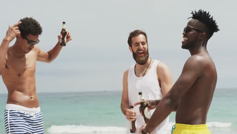 Group-of-mixed-race-male-friends-dancing-together-on-the-beach-4k