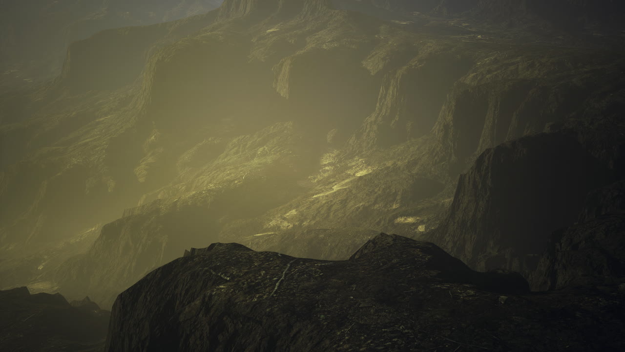 Misty mountain landscape with rocky terrain and soft golden light