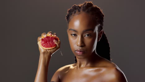 woman squeezing a grapefruit