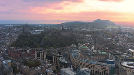 aerial view of edinburgh castle and misty cityscape skyline at sunset, scotland uk, drone shot
