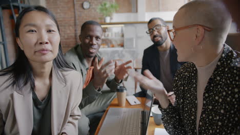 Diverse Team Having a Meeting/Discussion in a Cafe