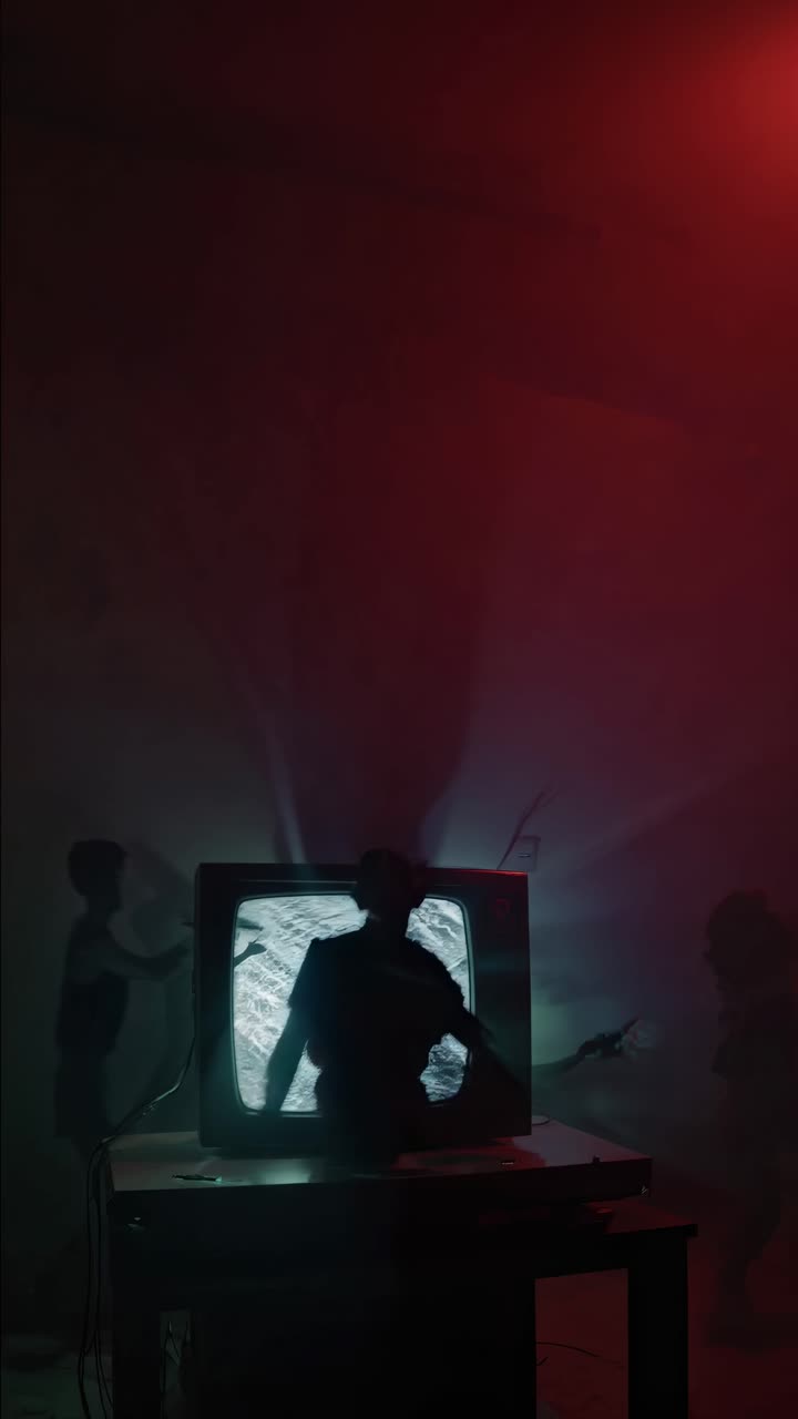 Vintage television broadcasting static, shadowy silhouette emerging under crimson glow, generating haunting paranormal ambiance within dimly lit interior space