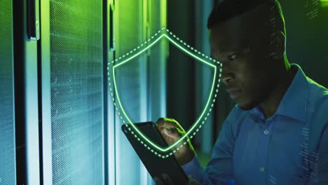 cybersecurity shield animation over man using tablet in server room