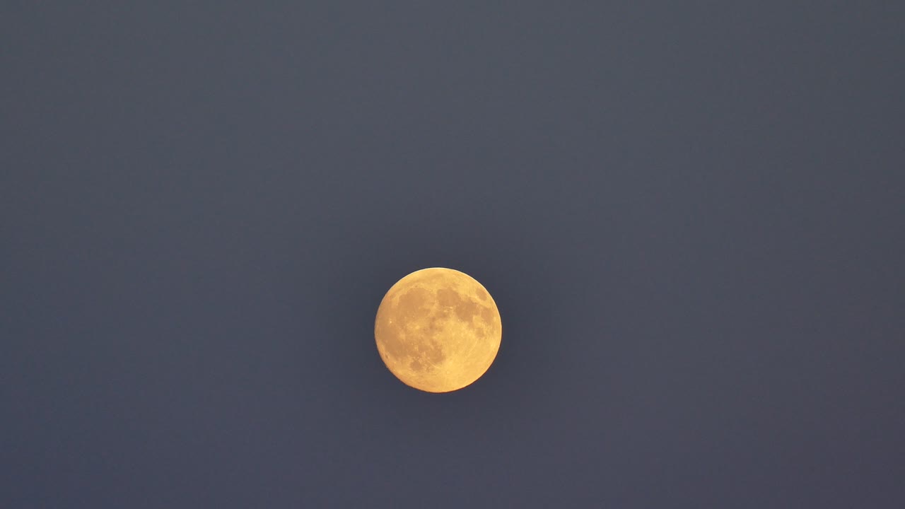 Full Moon Rising Over Grey Sky At Night