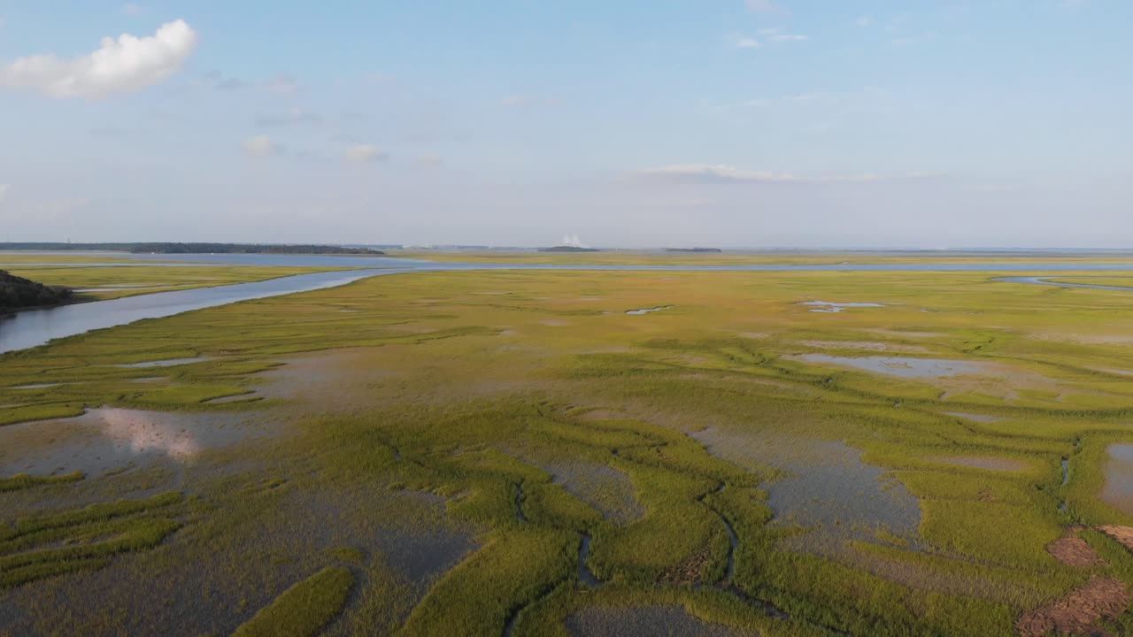 Aerial View of Marshland and Waterway into River in South Georgia with Sidney Lanier Bridge in Background