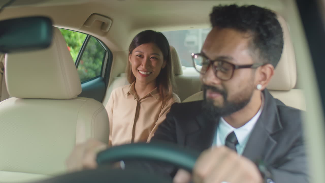 Businesswoman Sitting in Car with Personal Driver