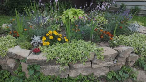 beautiful circular floral arrangement in a romanian garden with colorful blooms and stone wall