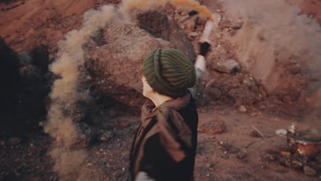 happy woman dancing with colored smoke bomb in dystopian world