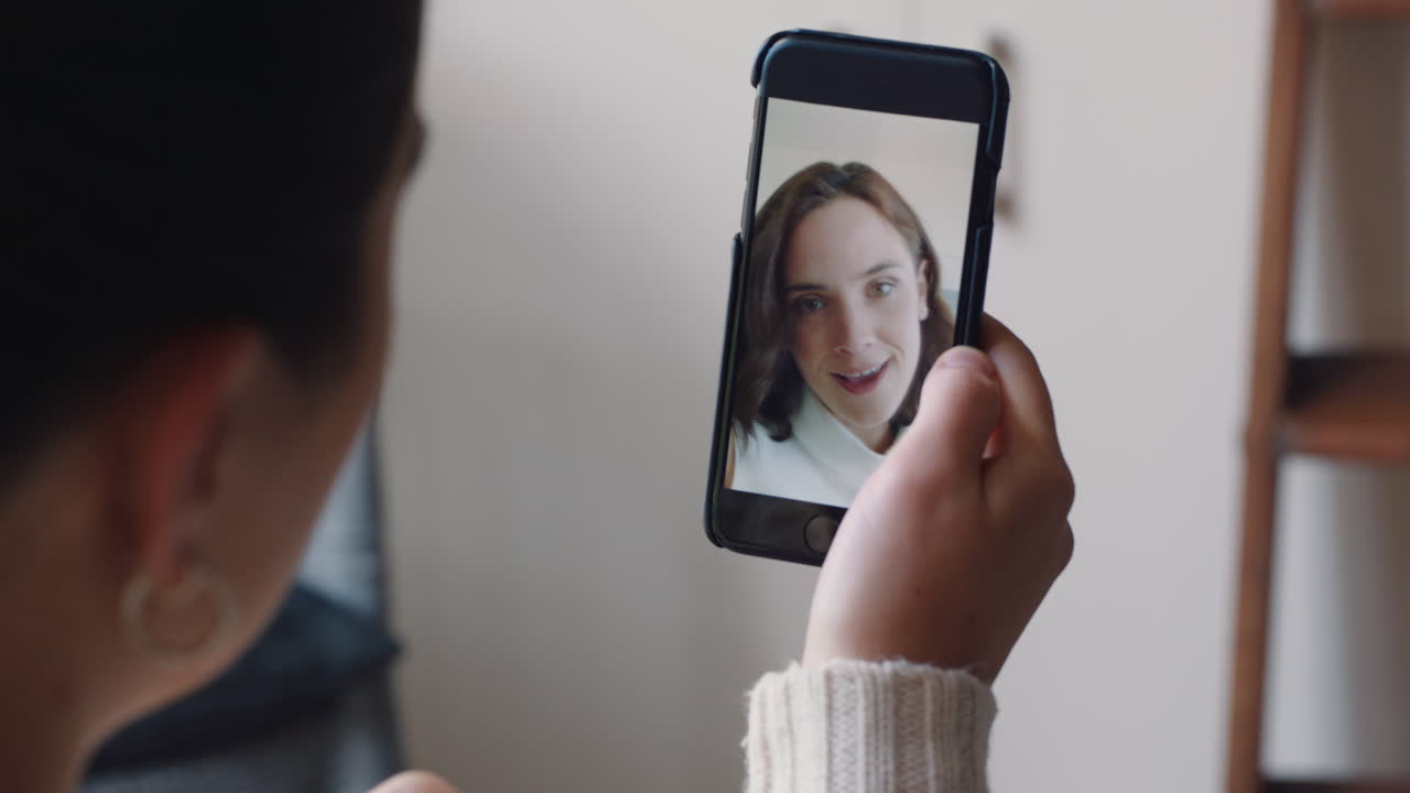 mujer joven teniendo video chat usando teléfono inteligente en casa hablando con un amigo disfrutando de la conversación compartiendo estilo de vida en el teléfono móvil