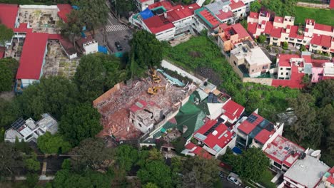 demolished house with a backhoe, captured by drone.