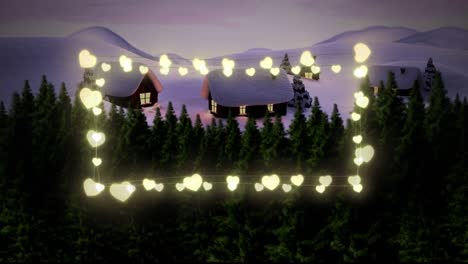 luces de hadas en forma de corazón amarillo contra el paisaje de invierno con casa y árboles