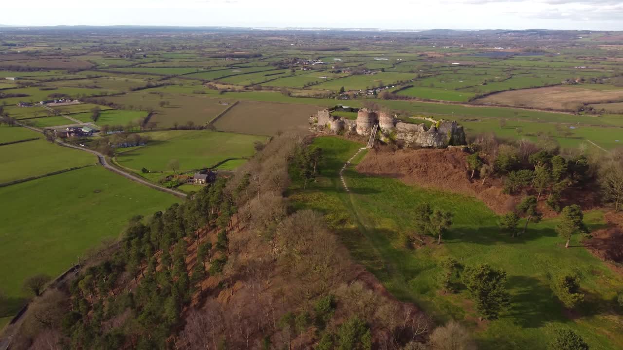 Advancing and circling towards front entrance of Beeston Castle medieval ruins with incredible landscape beyond - Cheshire, England, UK