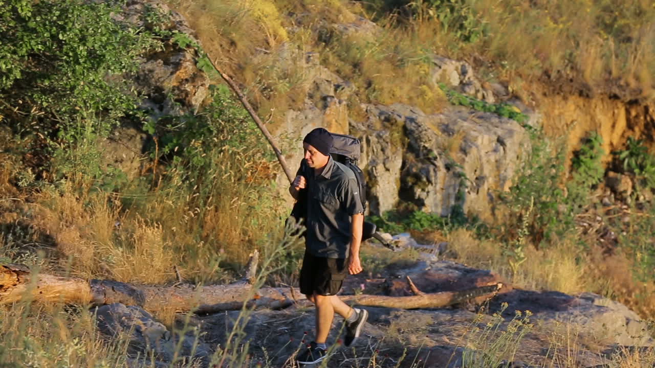 Male Rising On The Hill. Adult man hiker rising between the hills