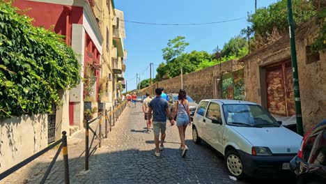 a couple walks hand-in-hand in naples