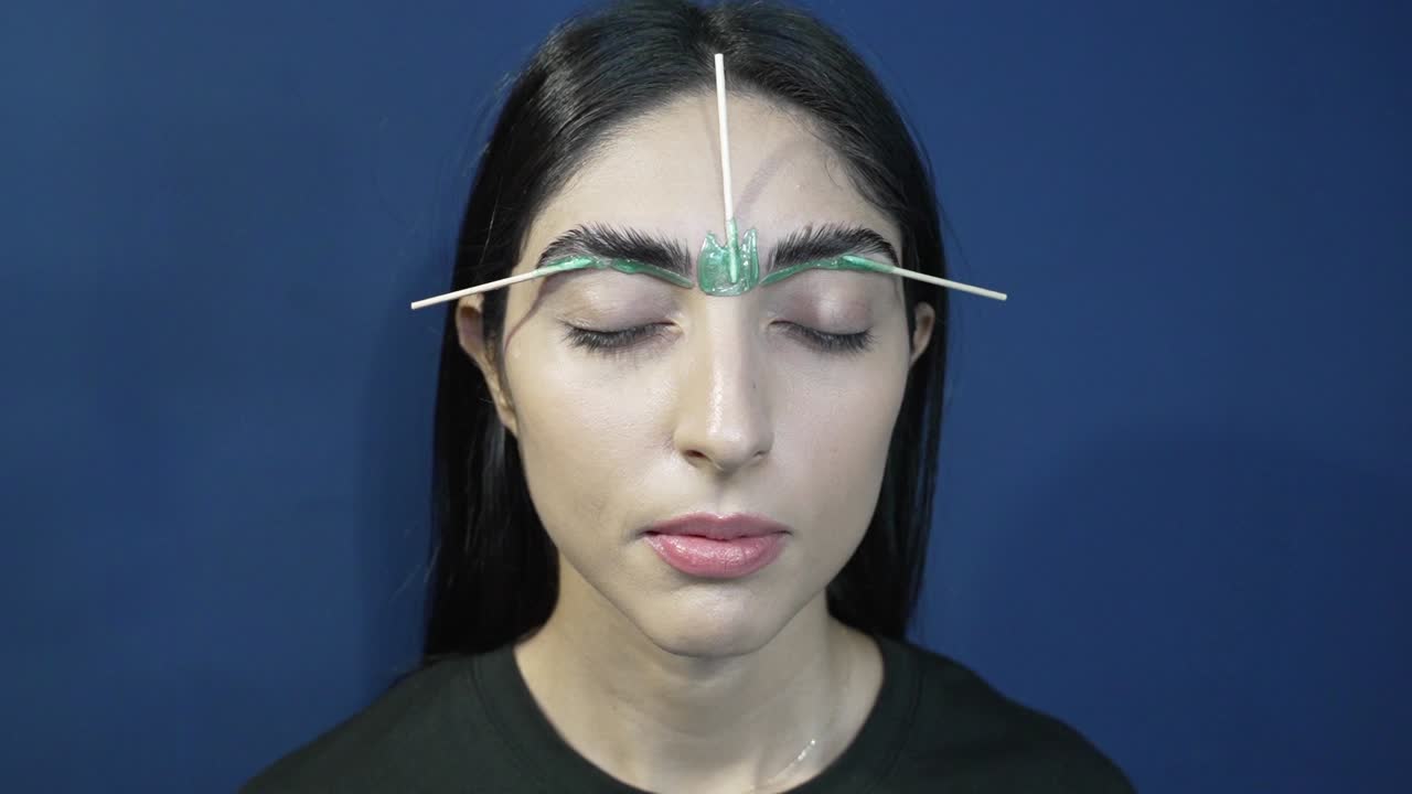 Eyebrow Waxing Closeup: Woman with Eyes Closed