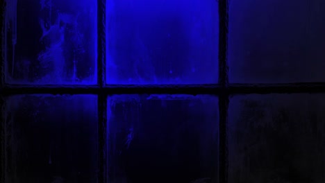 close up of police car lights flashing red and blue outside a dirty window at night, creating a tense and dramatic crime scene atmosphere