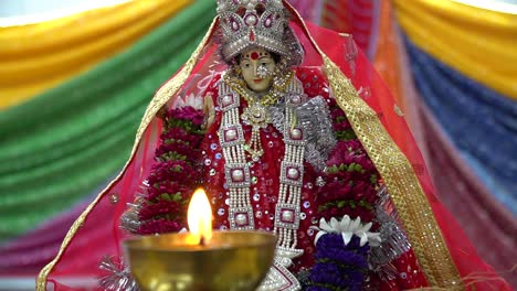 lit brass lamp with hindu goddess durga mata ji at celebration of navratri