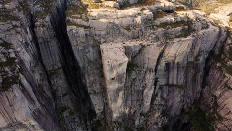 iconic preikestolen, norway. captured from above, vast fjord landscape and sunlit mountain peaks.