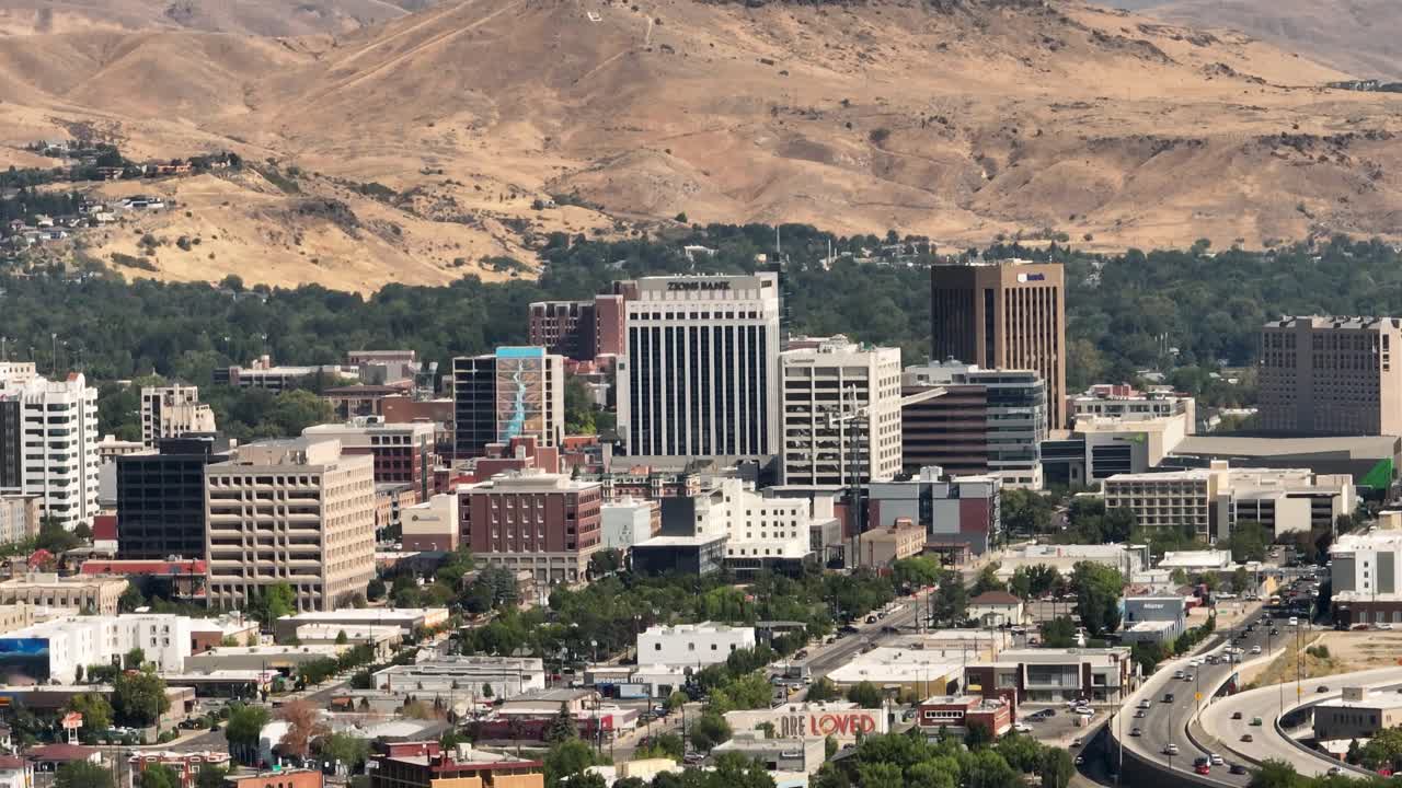 Downtown Boise, Idaho city skyline with arid, dry mountains on a summer day