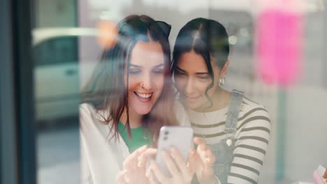 Window,-women-friends-and-smartphone-with-social