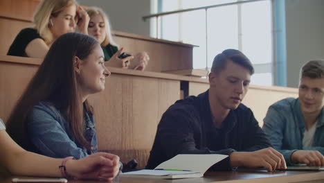 cheerful students are using smartphones and chatting during break between lectures at university. modern technology. cheerful students multiethnic group are