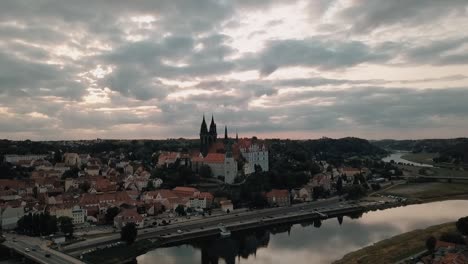The-cloudy-sky-reflects-off-the-Elbe-river-in-front-of-the-Albrechtsburg-castle-in-Meissen