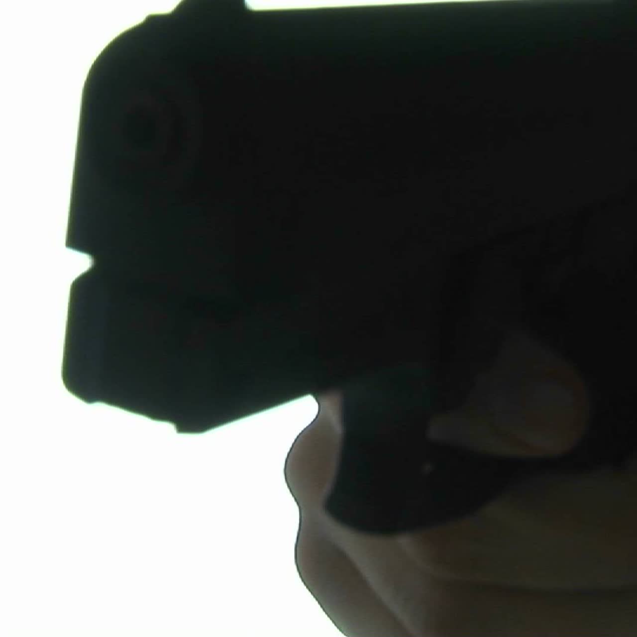 A gun is pointed at the camera