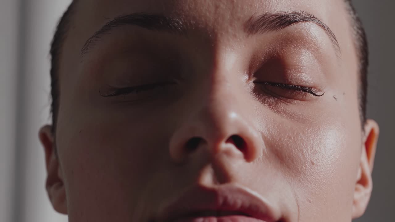 Close-up video of a serene face with closed eyes, capturing tranquility