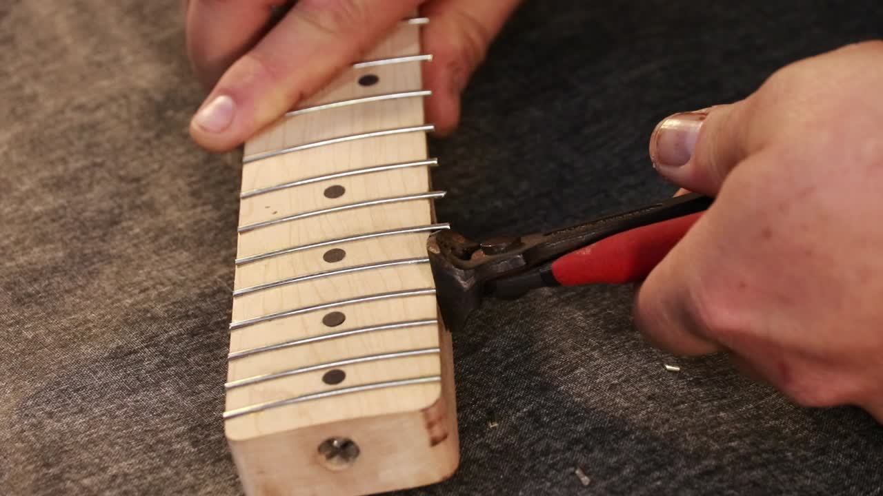 Frets being cut on new guitar neck