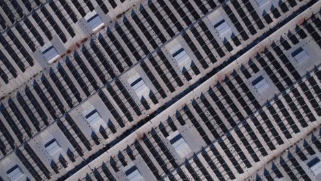 solar panels installed on a roof of a large industrial building or a warehouse. industrial buildings in the background. horizontal photo.