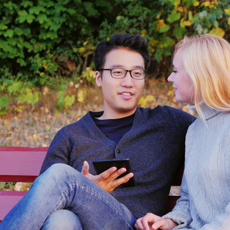 friends relax in the park and use a tablet 2