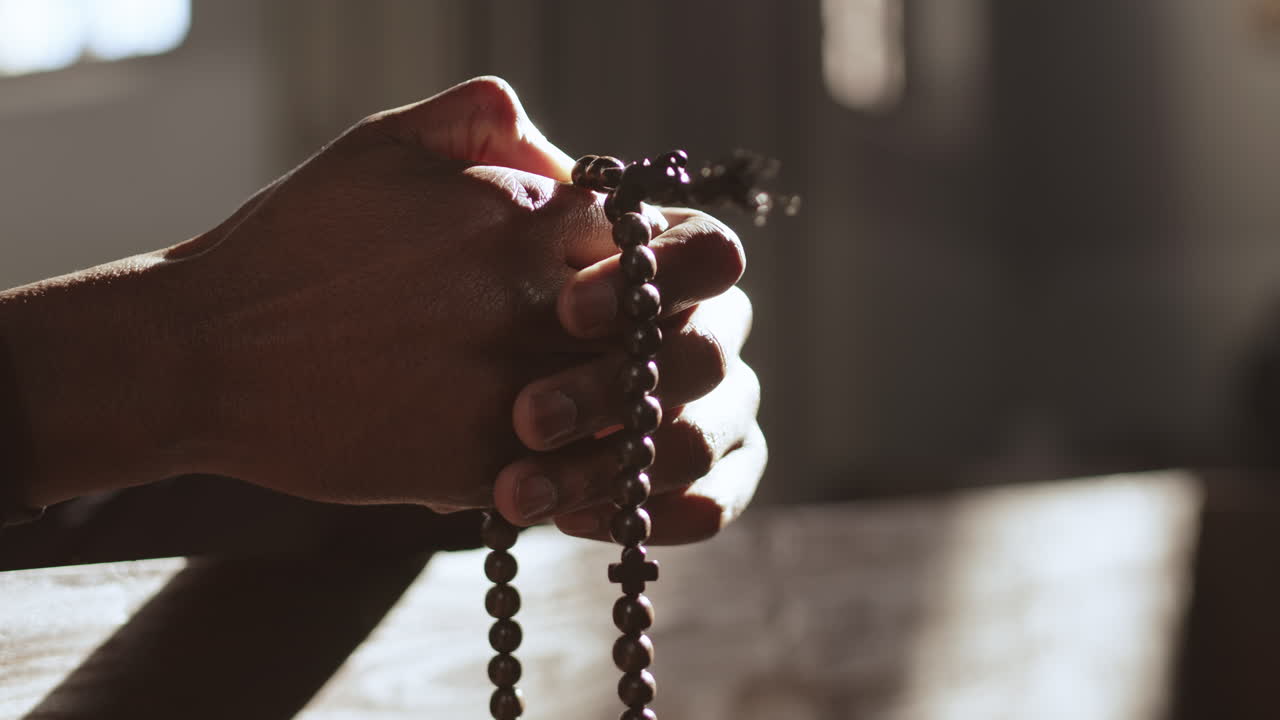 Hands of Unrecognizable African-American Man with Rosary Beads