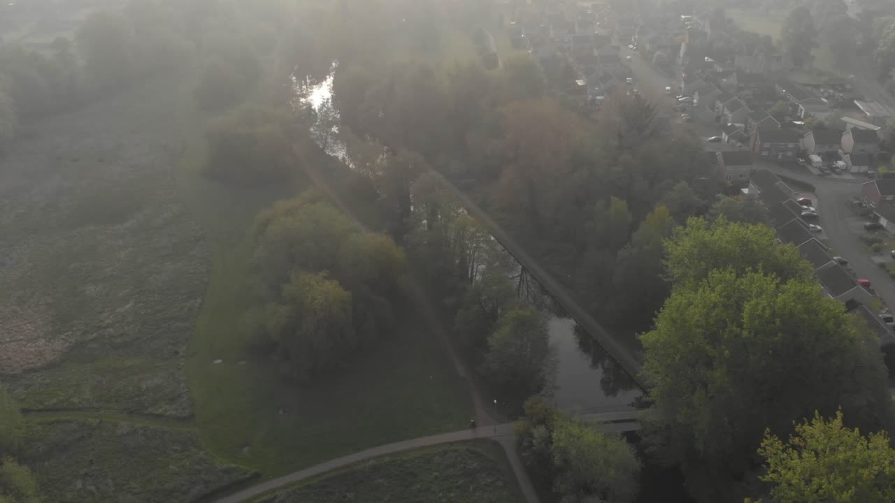 Aerial drone clip over a river and forest area in the countryside of Thetford in England