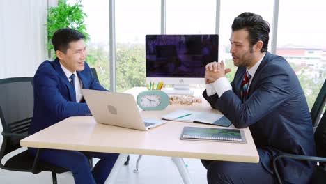 two business people talk project strategy at office