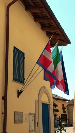 italian and eu flags on a building facade