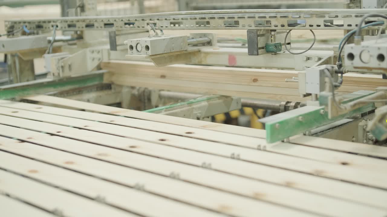 Automated Conveyor System Moving Wooden Planks in a Factory