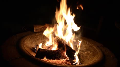 dazzling camp fire lights up the night in man made fire pit