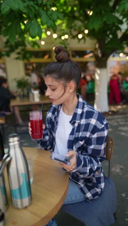 young woman relaxing in an outdoor cafe