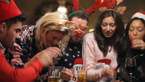 group of friends enjoying christmas drinks in bar