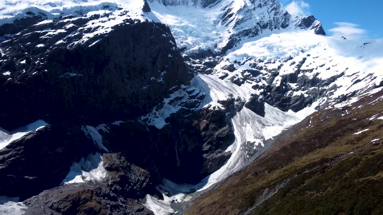 Drone view of mountains. ice and glaciers on a sunny day at Rob Roy Glacier, Wanaka, New Zealand.