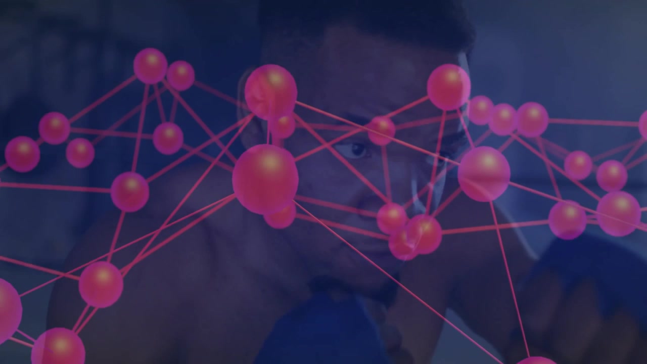 Man sitting on sofa viewing digital network overlay in tech demo, with pink spheres connecting