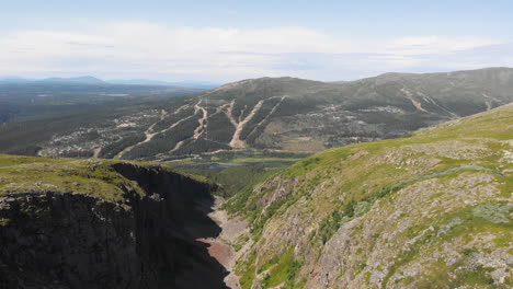 incredible aerial shot flying over a mountain valley and canyon in sweden