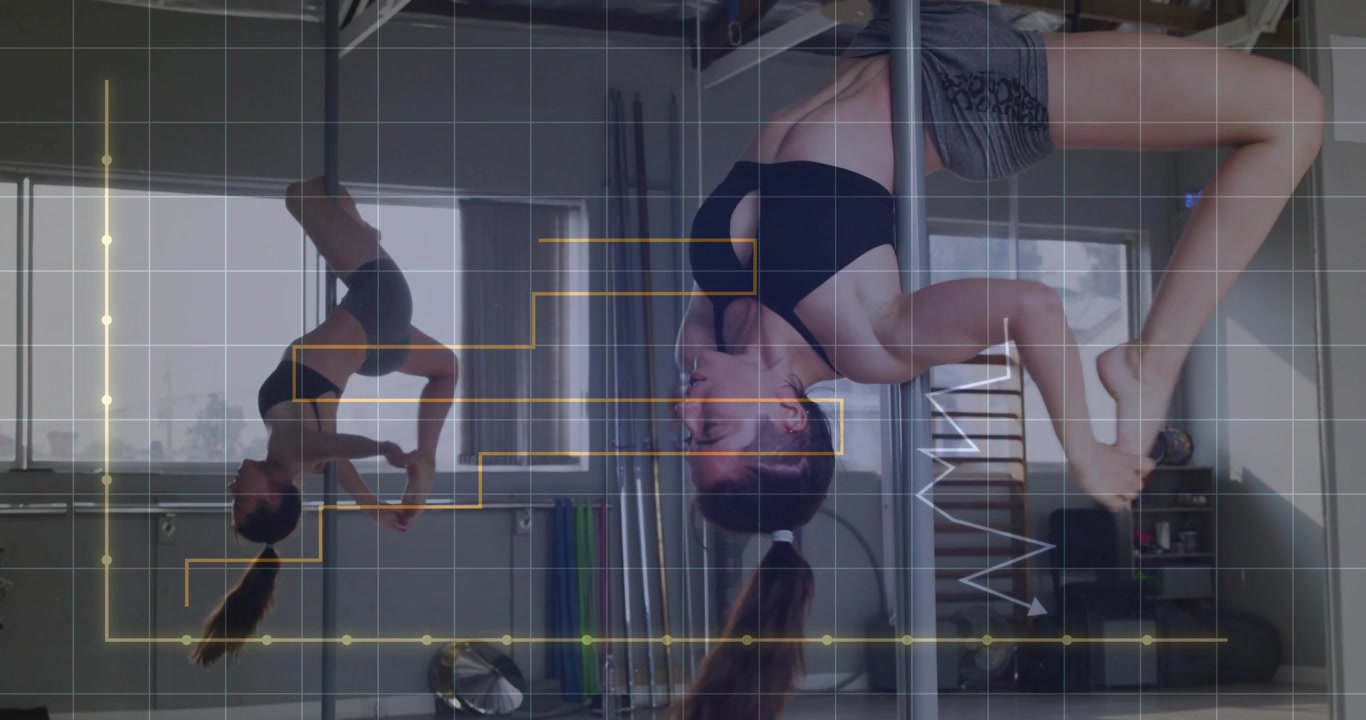 Fitness dancer gripping chrome pole in studio mirror performing inverted spins showcasing strength