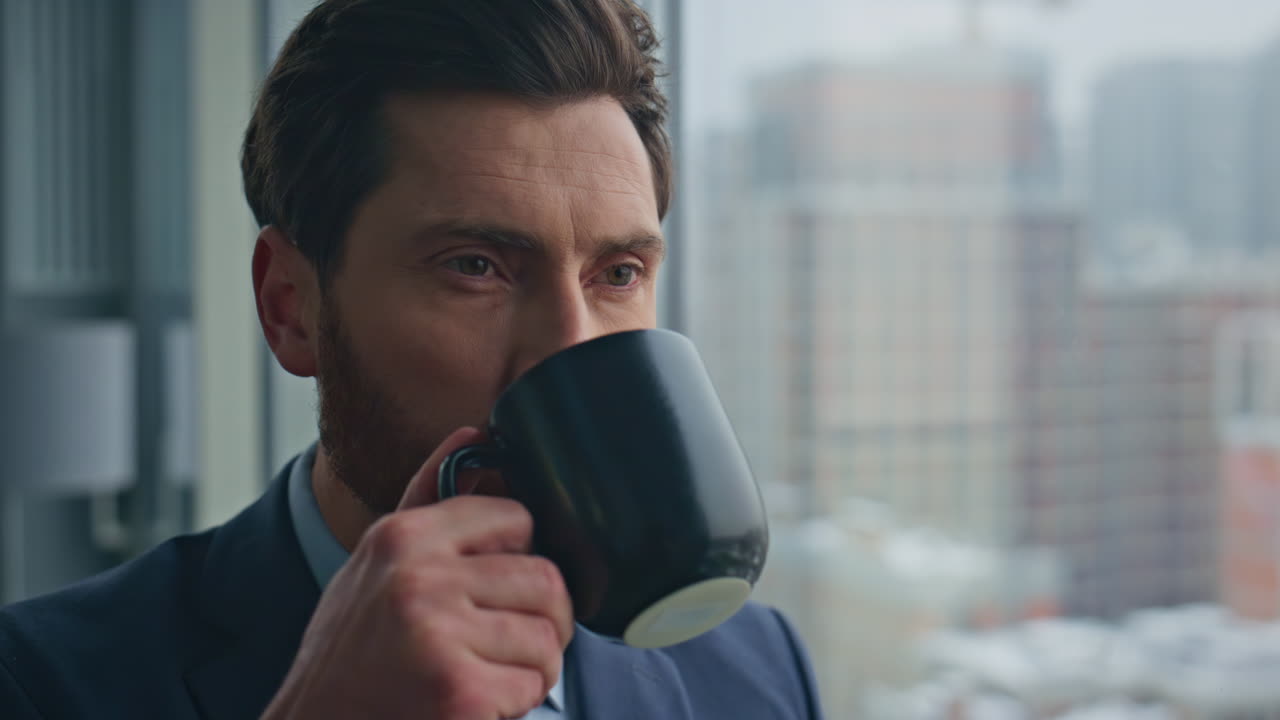 Corporate worker standing glass office looking window closeup. Manager drinking