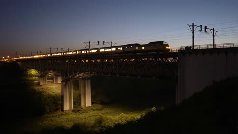 train crossing a bridge at dusk